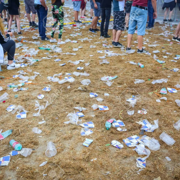 Brezje, Croatia - 20th July, 2019 : Detail of plastic cups and garbage on the floor after whole night of partying on the Forestland, ultimate forest electronic music festival located in Brezje, Croatia.